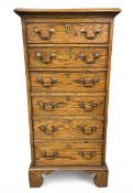 A 20th century Georgian style oak tallboy chest of six cockbeaded drawers raised on shaped bracket