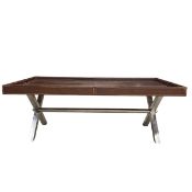 A contemporary coffee table with brown leather upholstered tray top raised on a polished metal x-