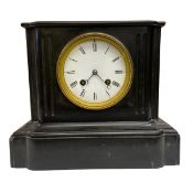 An early 20th century slate mantle clock with enamelled dial bearing Roman numerals raised on a