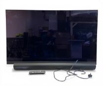 A Panasonic model TX-65HZ1500B OLED 4K tv with remote and paperwork together with a Sonos sound bar.