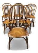 A set of six 20th century stick-back Windsor dining chairs with shaped elm saddle seats raised on