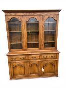 A contemporary 19th century style oak dresser or library bookcase with dentil moulded cornice over