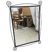 A contemporary wall mirror with rectangular plate in a scrolled wrought metal frame. 107x73cm.