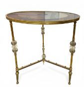 A 20th century Hollywood Regency style centre or occasional table with circular black and