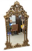 A contemporary Rococo style carved giltwood wall or overmantle mirror with shaped plate in a