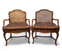 A pair of mid-century faux bamboo mahogany bergere armchairs each having a shaped cane back and seat