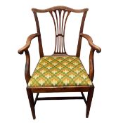 A Georgian oak open armchair in the Hepplewhite style with shaped camel back and wheatsheaf splat