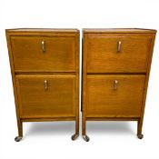 A pair of early 20th century oak Art Deco filing cabinets with square tops over two fall front