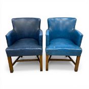 A pair of 20th century blue leather upholstered tub armchairs raised on straight stretchered
