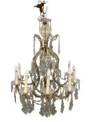 A Marie Therese style chandelier with shaped and bevelled cut glass drops suspended from a shaped