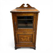 A 19th century rosewood music cabinet with swan neck pediment over a glazed satinwood strung cabinet