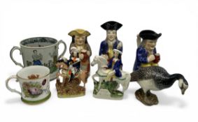 A mixed lot of 19th century and later earthenware ceramics to include an early Staffordshire toby