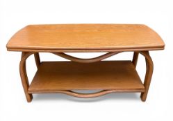 A mid-century retro ash coffee table with lozenge top raised on bentwood supports united by an