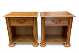 A pair of vintage oak bedside tables each with square thumb-moulded top over the single frieze