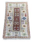 A contemporary Soumak style rug with a row of five central guls over a chocolate ground within