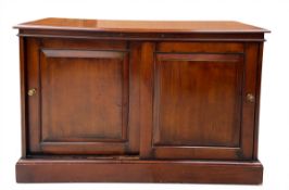 A Victorian style mahogany side cabinet with plank top over brushing slides and panel doors raised