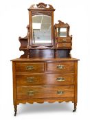 A late 19th century Art Nouveau style walnut dressing chest having a carved and shaped