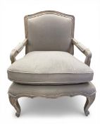 A contemporary French style fauteuil armchair with shaped back and calico upholstered, cushioned
