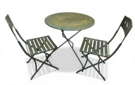 A vintage green painted metal French style bistro garden table together with the pair of matching
