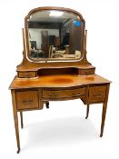 An Edwardian mahogany dressing table with shaped swing mirror and superstructural drawers over the