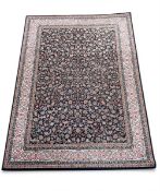 A contemporary Persian style Kashan carpet with an allover scrolling foliate field over a midnight