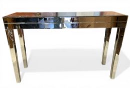 A vintage Hollywood Regency style mirrored console table raised on tapered square section