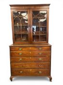 A Georgian mahogany secretaire bookcase with moulded cornice over glazed cabinet doors enclosing