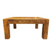 A vintage teak coffee table with square figured top over the carved frieze raised on straight