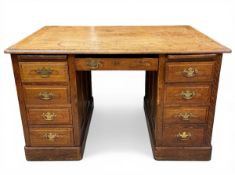 An early 20th century oak twin pedestal desk with thumb-moulded top over an arrangement of two