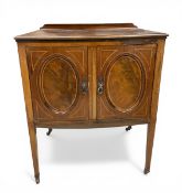 An Edwardian mahogany side cabinet with shaped gallery back over the figured panel cabinet doors