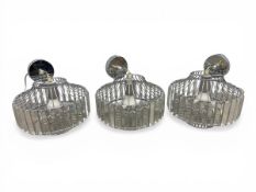 A set of three contemporary ceiling lamps each with a band of baguette cut glass lozenges set into a