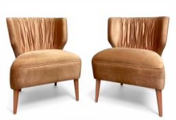 A pair of contemporary Portuguese 'Lipstick' lounge chairs with shaped and pleated backs over the