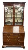 A Georgian mahogany bureau bookcase in two parts with dentil-moulded cornice and marquetry inlaid