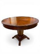 A vintage Regency style mahogany Jupe extending dining table with sectional circular top over the