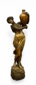 An early 20th century bronzed and gilded ceramic figure of a water carrier by Cherc for Goldscheider
