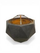 A contemporary cast metal Gardenline fire pit of octagonal, faceted form with a faux stone finish.