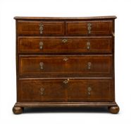 An early 18th century walnut chest of two short over three long feather-banded drawers raised on bun