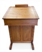 A 20th century teak davenport with hinged slope enclosing a baize lined interior over four