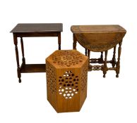 A 19th century style oak drop-leaf table with carved oval top over the turned and stretchered gate-