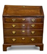 A Georgian mahogany bureau with fall-front enclosing a fitted interior over four long graduating