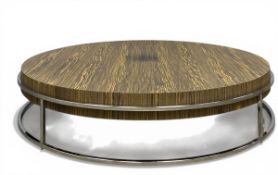 A contemporary zebrawood coffee table with circular top raised on a bent chrome frame by Natuzzi.