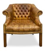 a 19th century distressed tan leather deep-buttoned back club armchair with scrolled arms raised
