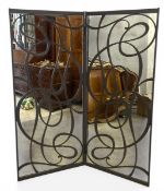 A large full height vintage mirrored folding screen with allover scrolling openwork wrought metal