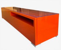 A contemporary TV or HI Fi cabinet in a lacquered finish with plate glass top. H.49 W.240 D.61cm
