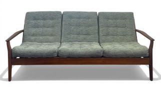 A mid-century Danish three seater sofa with removable sage green upholstered cushions on a shaped