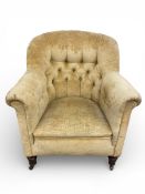 A 19th century deep buttoned tub armchair on turned supports. (One castor missing as seen). H.83 W.