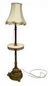 A C.1900 French brass floor lamp with tasseled shade over the fluted stem and circular marble