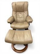A vintage Norwegian cream leather uphostered Stressless reclining armchair with the matching