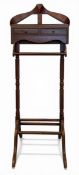A vintage style mahogany valet stand with coat hanger over the single frieze drawer raised on