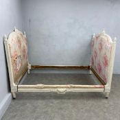 A 19th century French directoire bed with carved and painted frame upholstered in pink toile de jouy
